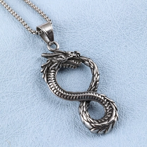 Detailed close-up of a silver Viking dragon pendant with intricate metallic textures