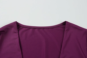 Detailed close-up of the smooth purple fabric and neckline stitching of the sexy dress