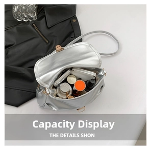 Inside view of silver crossbody bag showing storage capacity for phone and perfume