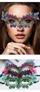 Close-up of vibrant gradient lace mask with 3D butterfly accents and sparkling rhinestones