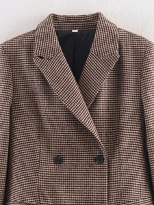 Detail view of brown houndstooth blazer with double-breasted buttons and size S tag