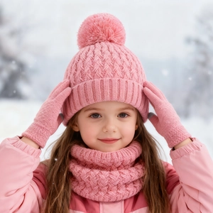 Close-up of pink winter set for girls featuring knit hat with pom-pom, scarf and gloves