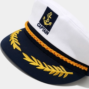 Detail of captain hat with gold embroidery wheat ears and anchor badge on white crown