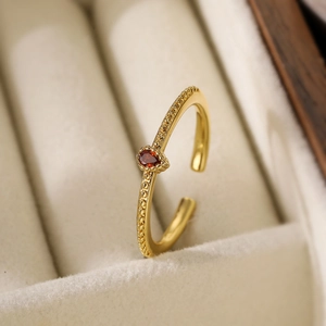 18K gold plated ring featuring a teardrop red zircon and detailed beaded texture