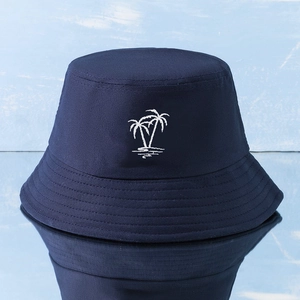Detail of white coconut tree embroidery on a navy blue cotton Y2K bucket hat