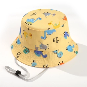 Detail of yellow kids bucket hat with cartoon dinosaur prints and adjustable chin strap