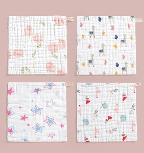 Detail of four ultra-soft 6-layer cotton gauze baby towels with floral and animal prints