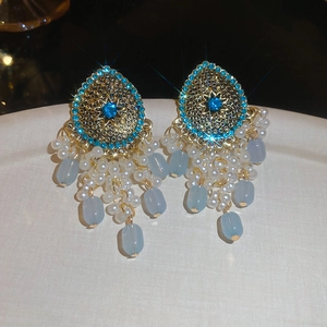 Ethnic gold drop earrings with blue stone starburst and tiered pearl beaded tassels