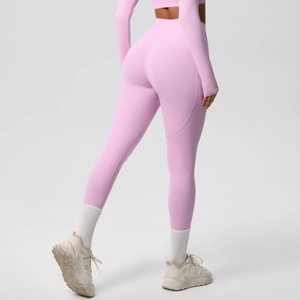 Detail view of pink high-waist yoga leggings with seamless stitching and lifting effect