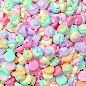 Macro shot of colorful resin candy stars and heart beads for DIY nail art and jewelry