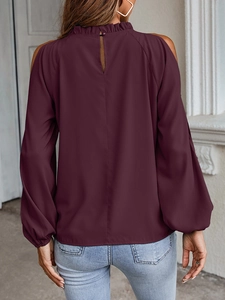 Detail of the ruffle collar and back button closure on a burgundy cold shoulder blouse