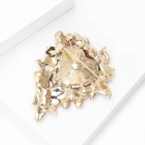 Back view of luxury gold alloy heart brooch with detailed embossed texture and secure pin
