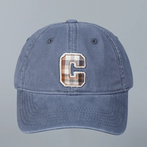 Detail of embroidered plaid C patch on washed cotton breathable baseball cap fabric