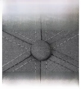 Macro shot of dark grey baseball cap top button showing fine stitching and twill fabric texture