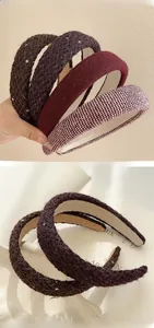 Detailed close-up of thickened tweed headbands in burgundy and dark plaid textures