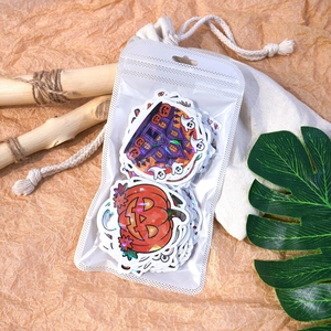 Detailed view of laser Halloween stickers with pumpkin and ghost motifs in packaging