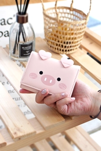 Close-up of pink PU leather tri-fold wallet with cute pig ears and fine stitching