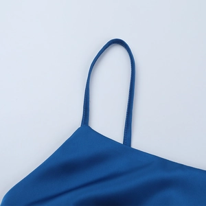 Close-up of sleek dark blue satin fabric and delicate spaghetti straps on a dress