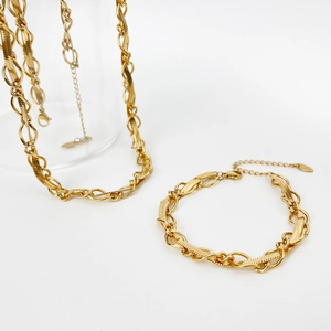 Detail of 18k gold plated blade chain necklace and bracelet with twisted link texture