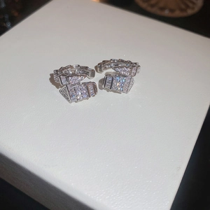 Silver snake-shaped ear bone clips with sparkling zircon stones in a Serpenti style