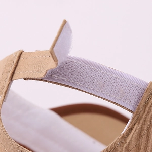 Vue macro de la fermeture à scratch sur une casquette de baseball kaki pour enfants