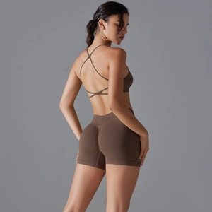 Detail of cross-back sports bra and high-waisted seamless scrunch shorts in dark brown