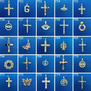 Assorted gold-plated necklace pendants with colorful gemstones and unique shapes