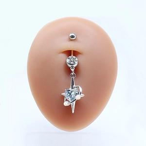 Silver heart belly button ring with blue gem and star charm on a silicone model