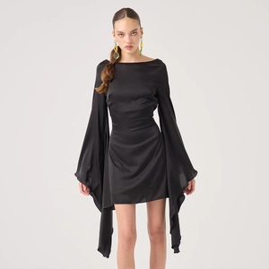 Detail view of black backless satin mini dress featuring dramatic oversized flare sleeves