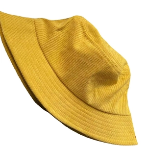 Classic yellow corduroy bucket hat for women in retro minimalist style on white background