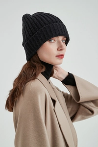 Profile view of a minimalist black knit beanie made from soft acrylic cashmere-like material