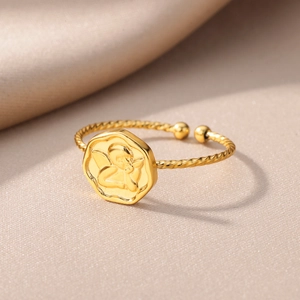 18k gold plated stainless steel spiral band ring with an angel relief on champagne silk