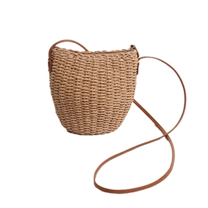 Brown straw crossbody bucket bag with leather strap for summer beach vacations