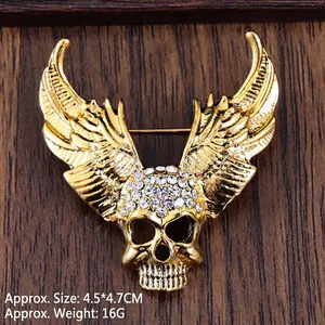 Golden winged skull brooch pin with sparkling white rhinestones for Halloween