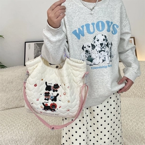 Quilted cotton tote bag with cute cat embroidery and pink straps in a lifestyle setting