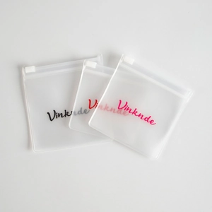 Close-up of translucent frosted EVA jewelry bags with slide zippers for earings