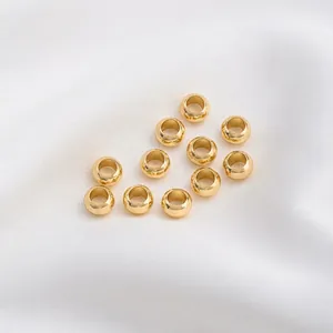 Macro view of 14K gold filled wheel beads with a polished mirror finish for DIY jewelry
