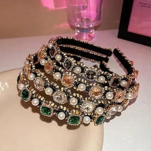 Vintage headbands with large pearls and emerald gemstones in a retro palace style