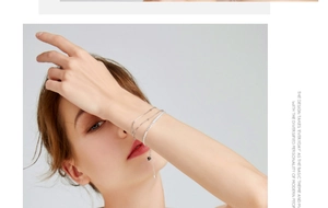 Detailed close-up of a silver minimalist layered bracelet set including a sleek tennis chain