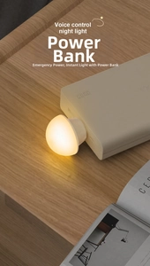 Detail of voice-controlled USB night light plugged into power bank with warm glow