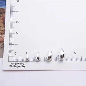 Size comparison of four S925 sterling silver olive beads on a measurement scale