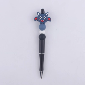 Detail view of cartoon bat silicone beads on a black plastic beaded pen for DIY crafts