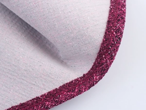 Detail shot of deep red tweed trim on a light gray vintage woven fabric edge