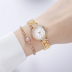 Detail of luxury gold quartz watch with rhinestone bezel and heart-shaped crystal bracelet