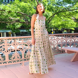 Detail of floral halter neck sleeveless dress with palm print in summer resort style