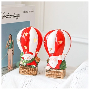 Close-up of Santa and snowman Christmas hot air balloon figurines with star cutouts