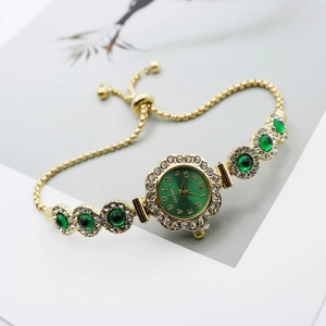 Detail of luxury gold bracelet watch with green dial and adjustable slider clasp