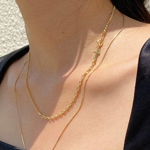 Layered gold cross pendant necklace featuring chunky link chain and smooth snake chain