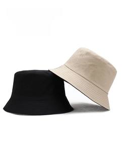 Detail of reversible cotton bucket hats in black and beige with durable canvas texture
