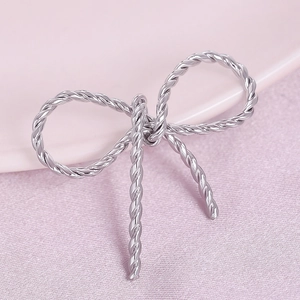 Macro shot of silver-tone bow pendant made of 304 stainless steel with a metallic finish